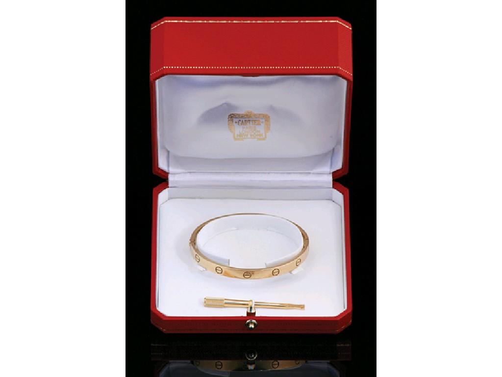 Appraisal: CARTIER AN CT YELLOW GOLD BANGLE with the typical screw