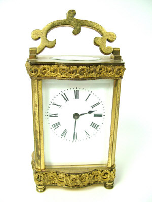 Appraisal: A brass cased carriage clock decorated with bands of scrolls