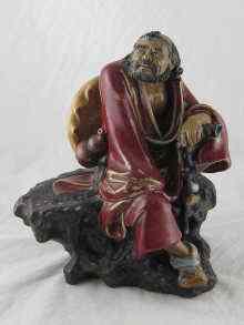 Appraisal: A Chinese ceramic figure of a traveller resting on a