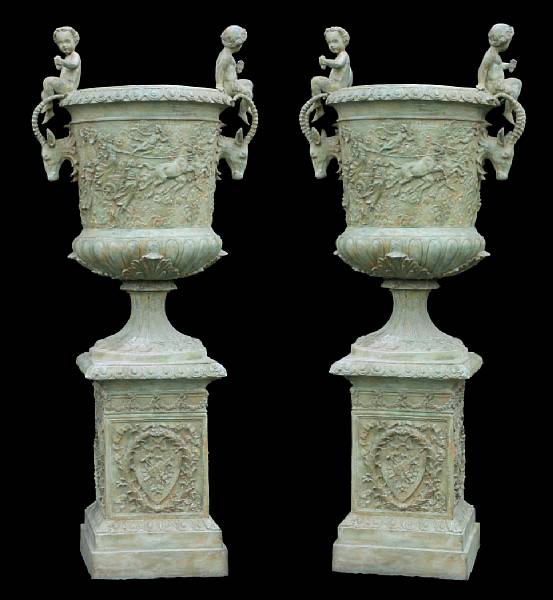 Appraisal: A pair of patinated bronze urns on pedestals modern Each