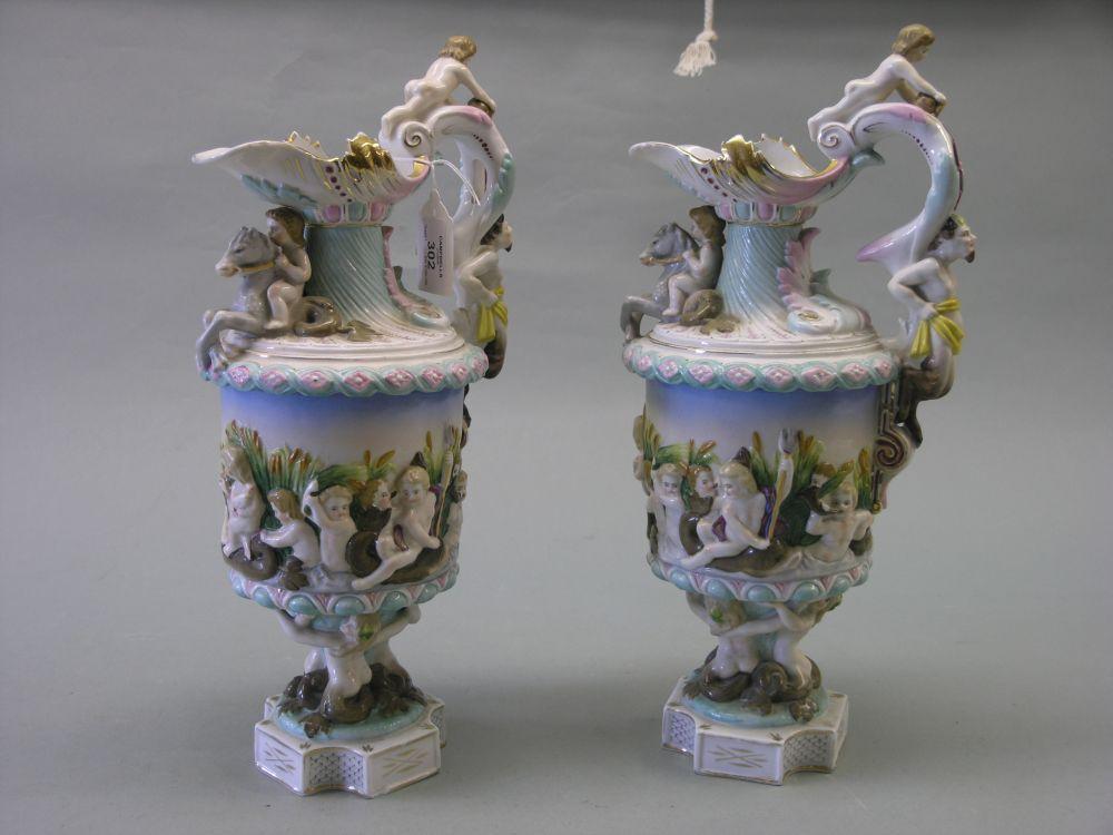 Appraisal: A pair of Italian porcelain ewers boldly moulded with nymphs