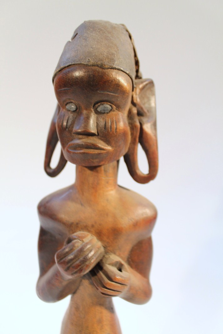 Appraisal: A heavily carved African figure of a gentleman with elaborate