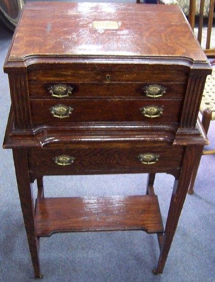 Appraisal: An Edwardian oak canteen the shaped hinged rectangular lid with