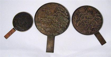 Appraisal: Three Japanese bronze mirrors th century The largest worked to