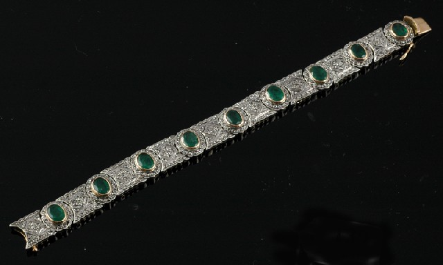 Appraisal: AN EMERALD AND DIAMOND BRACELET Comprising nine oval cut emeralds