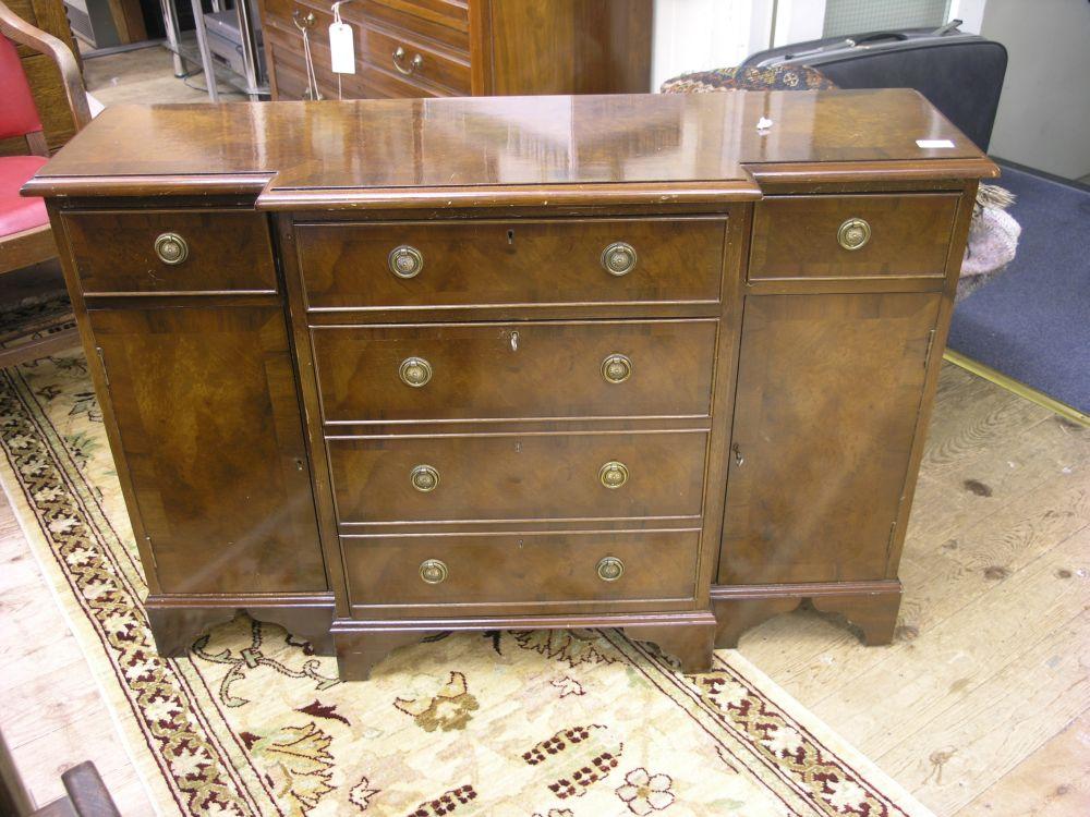 Appraisal: A reproduction burr walnut veneered breakfront sideboard of small proportions