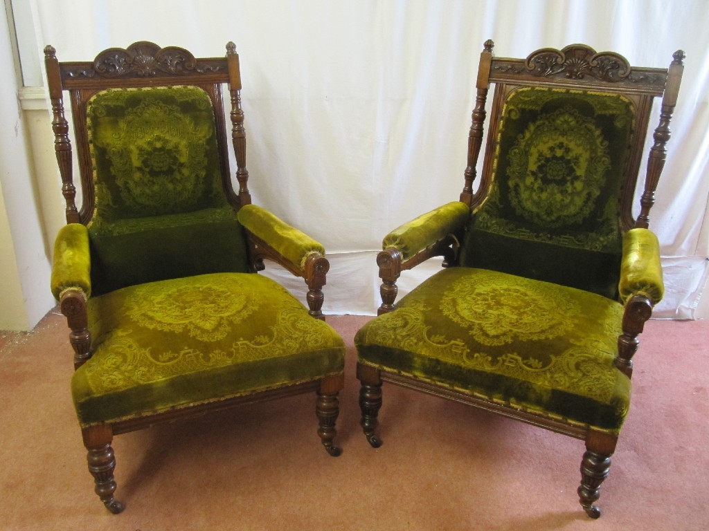 Appraisal: A pair of late Victorian oak parlour armchairs richly carved