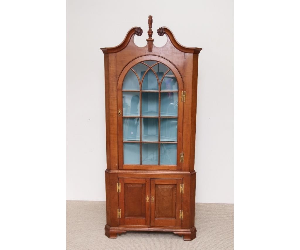 Appraisal: Tiger maple two-part corner cupboard circa having a broken arch