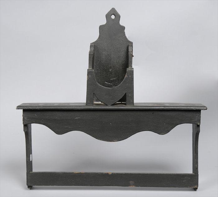 Appraisal: BLACK-PAINTED SPOON RACK The shaped back panel above open compartment