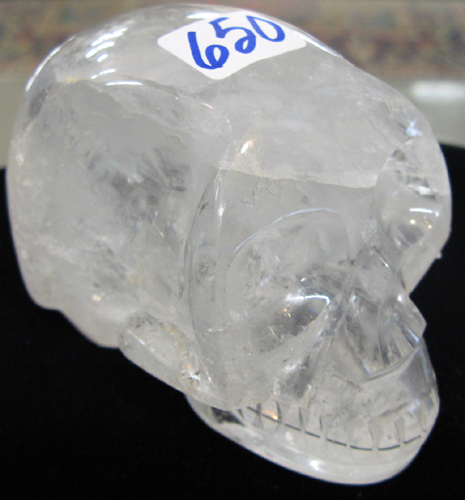 Appraisal: A NATURAL ROCK CRYSTAL SCULPTURE PAPERWEIGHT of a human skull