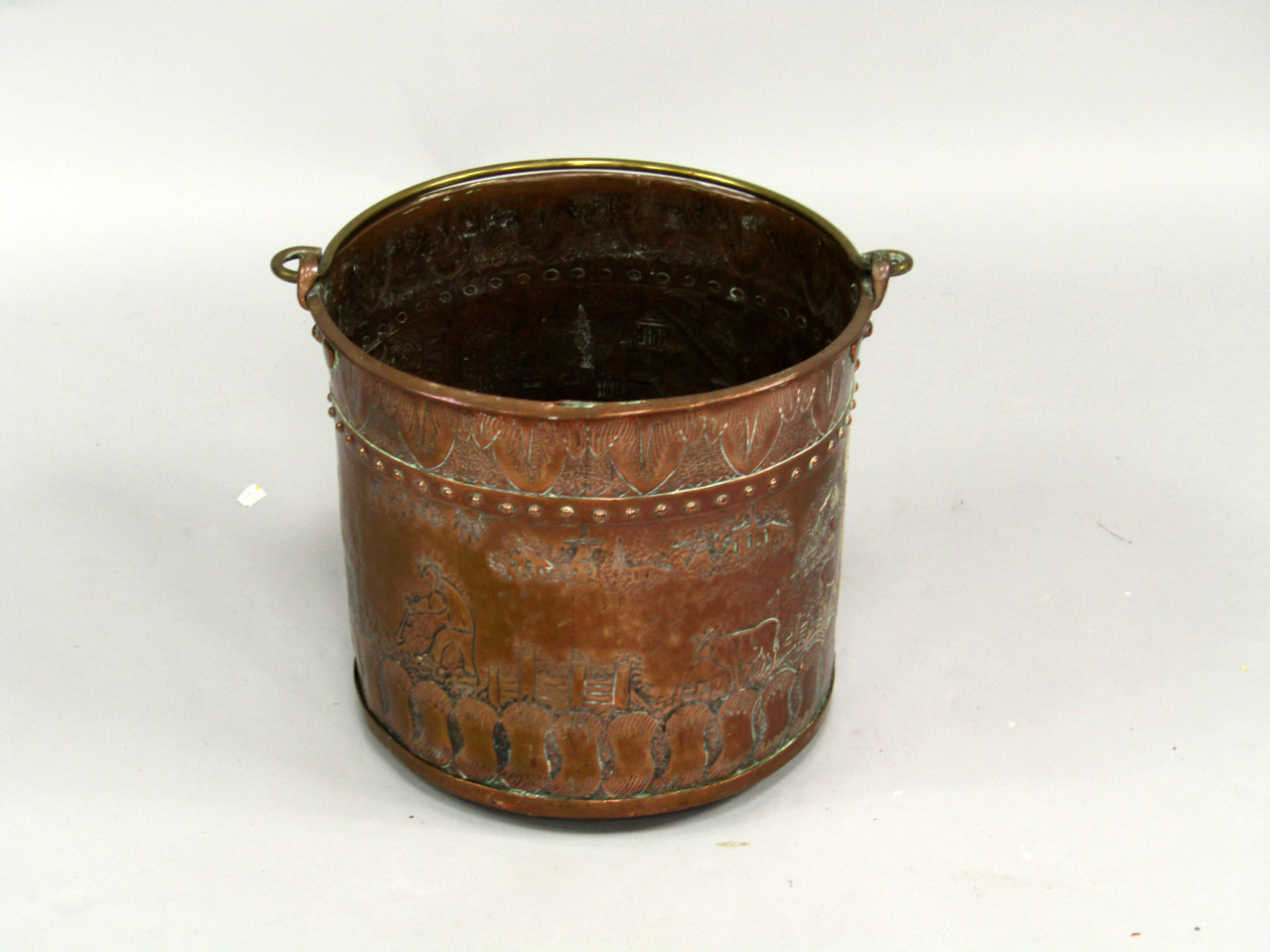 Appraisal: A copper log bin with brass swing handle and embossed