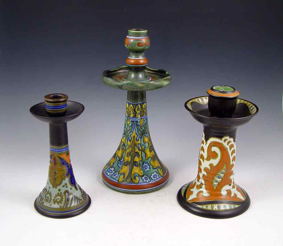 Appraisal: GROUP OF THREE GOUDA POTTERY CANDLE HOLDERS '' tall ''