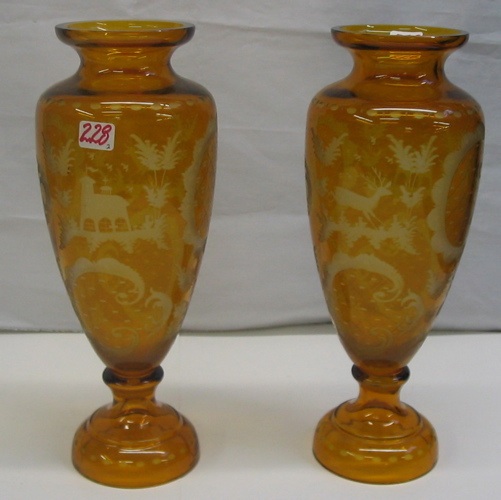 Appraisal: PAIR OF BOHEMIAN ENGRAVED AMBER GLASS GARNITURE VASES with designs