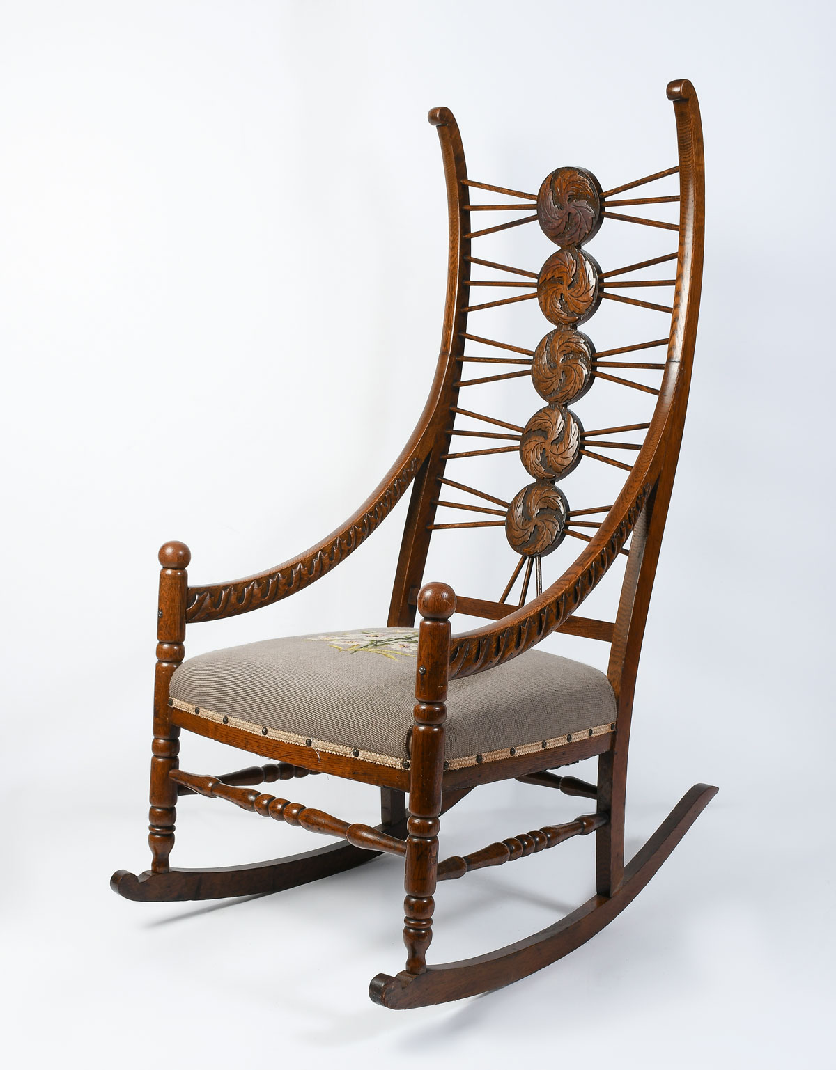 Appraisal: CARVED OAK ROCKING CHAIR WITH NEEDLEPOINT Having unique swirling foliate