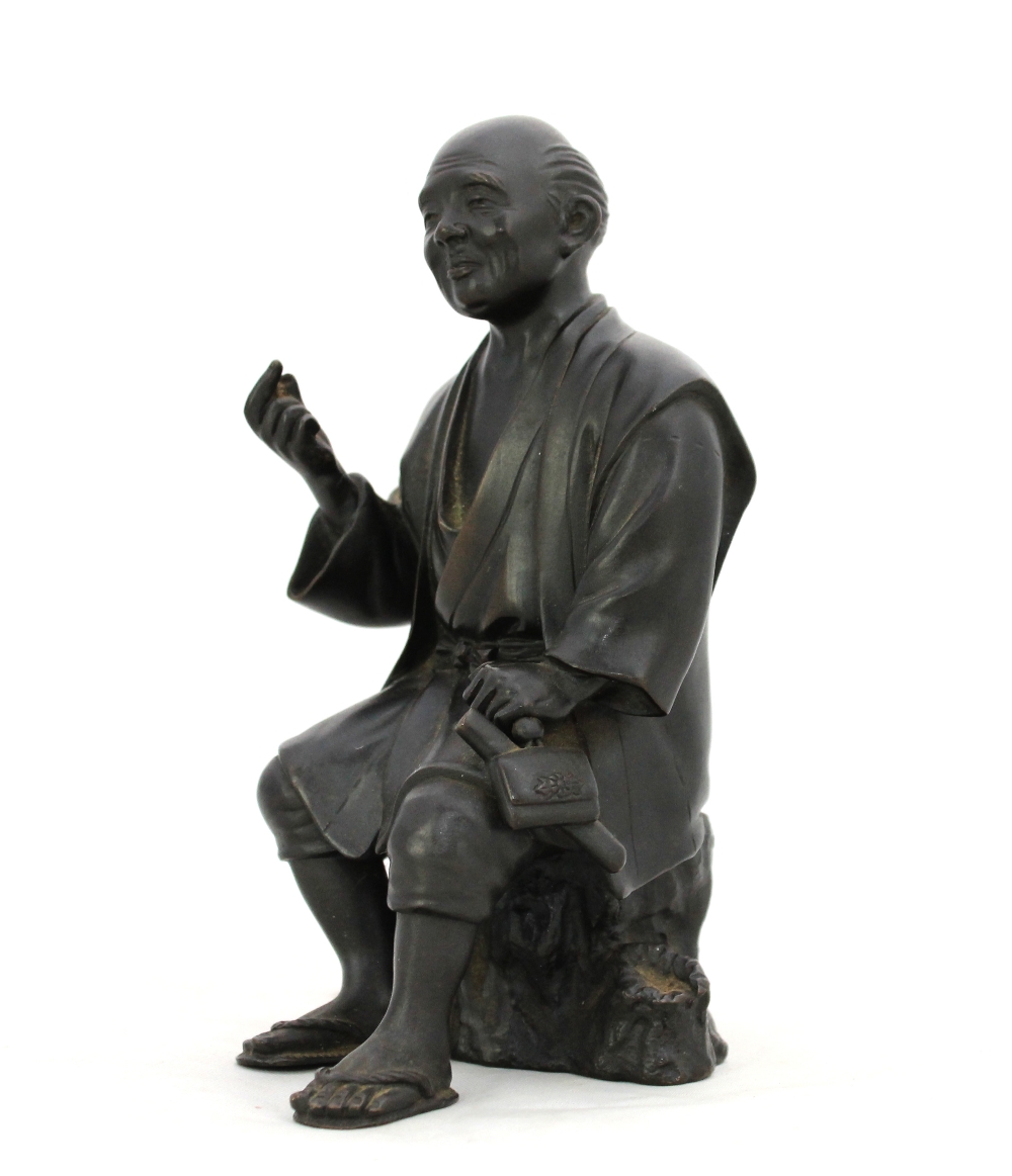 Appraisal: A Japanese bronze figure of a peasant Meiji Taisho period