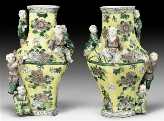 Appraisal: A PAIR OF YELLOW GROUND BISCUIT VASES WITH MODELLED BOYS