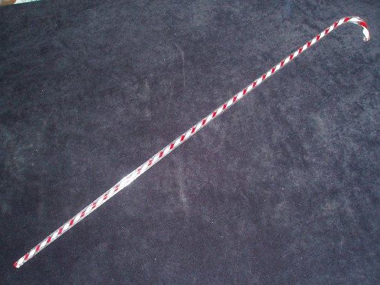 Appraisal: A Victorian glass cane with red and white spiral gauze