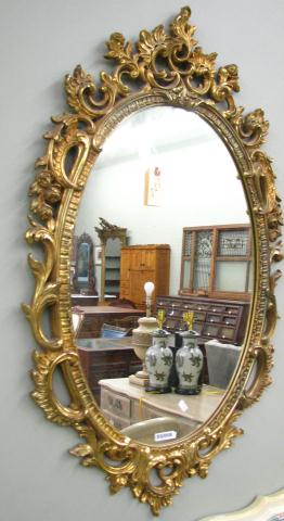 Appraisal: Oval Decorator Wall Mirror with leaf and scroll motif Antique