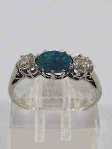 Appraisal: A white metal tests ct gold three stone black opal