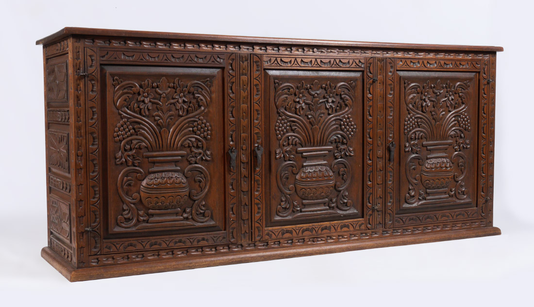 Appraisal: CONTINENTAL CARVED DOOR CREDENZA Doors carved with urn foliate and