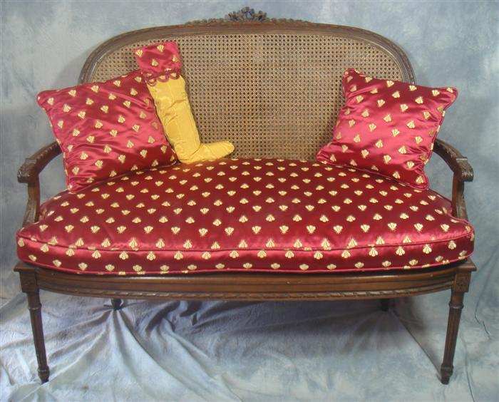 Appraisal: French style carved settee with caned back down cushion pillows