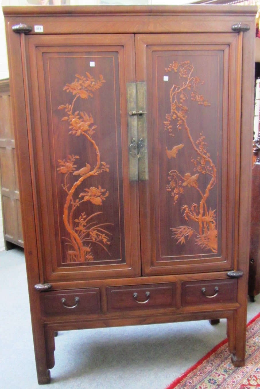 Appraisal: A th century Oriental hardwood two door wardrobe with relief