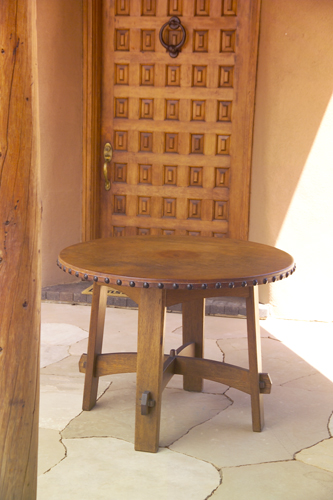 Appraisal: GUSTAV STICKLEY Early library table with circular tacked-on leather top