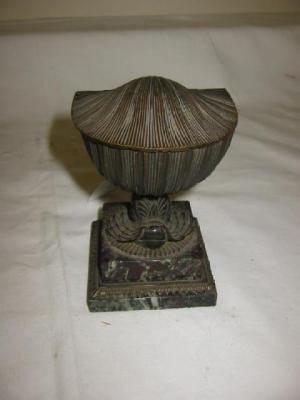 Appraisal: A BRONZE INKWELL modelled as a shell supported on a