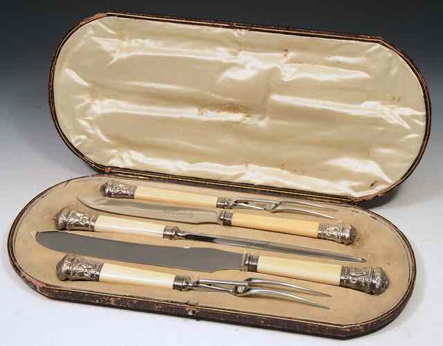 Appraisal: A CASED IVORY HANDLED AND SILVER MOUNTED CARVING SET two