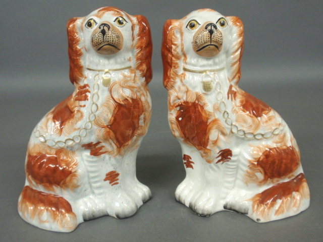 Appraisal: - Pair of Staffordshire seated red spaniels c h x