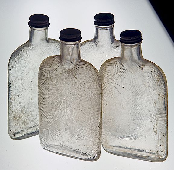 Appraisal: Box Lot of Bottles Exclusive on Bidsquare Four clear spiderweb