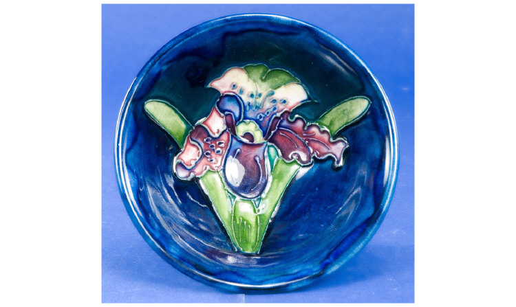 Appraisal: Moorcroft Small Footed Bowl Orchid pattern on Royal Blue ground