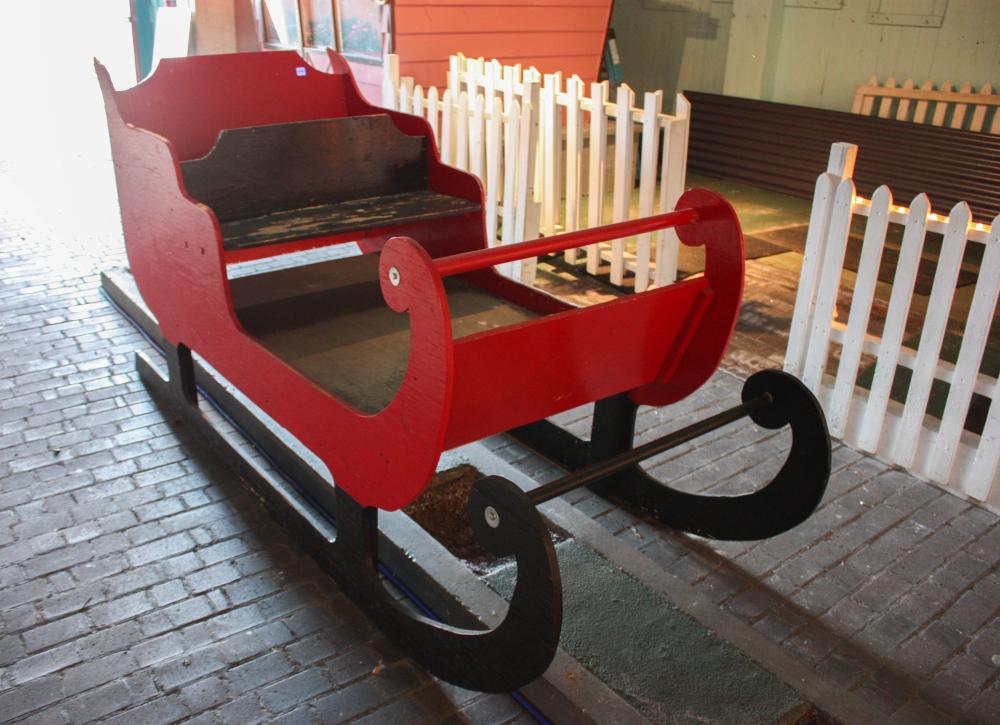 Appraisal: SANTA'S SLEIGH red and black painted plywood H x W