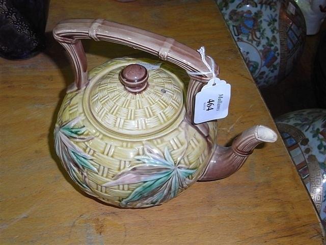 Appraisal: A TH CENTURY MAJOLICA TEAPOT on a yellow basket weave