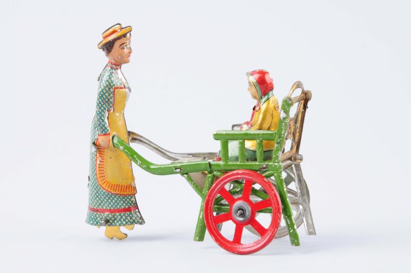 Appraisal: A German Tin Litho Woman Pushing Cart Penny Toy Unusual