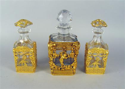 Appraisal: Three gilt-metal mounted glass decanters th century Comprising a large