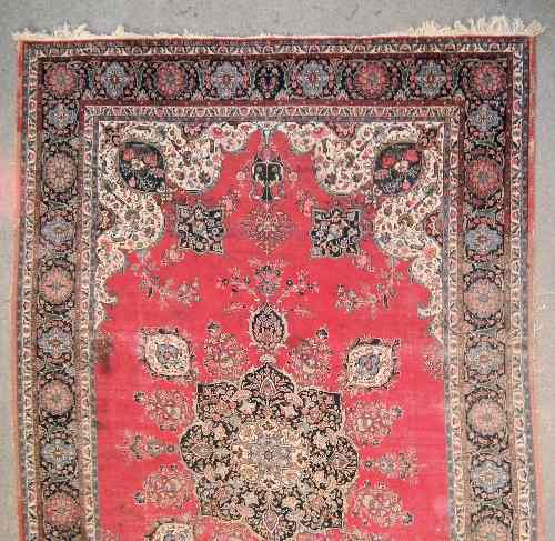 Appraisal: A Meshad carpet woven in colours with central star shaped