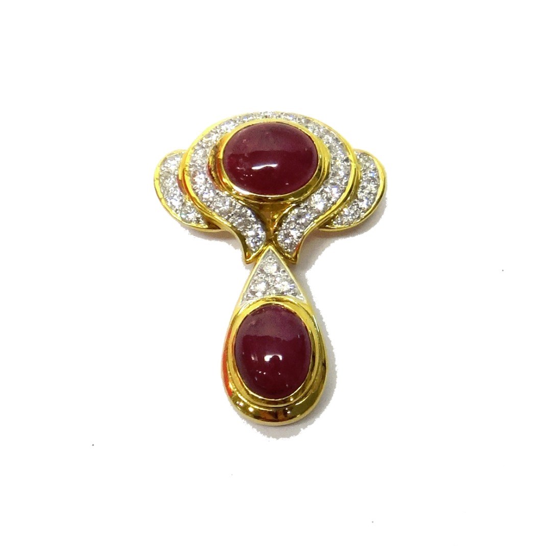 Appraisal: A gold diamond and ruby set pendant brooch of twin