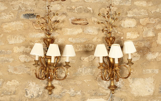 Appraisal: A PAIR OF ROCOCO GILTWOOD THREE BRANCH WALL LIGHTS of