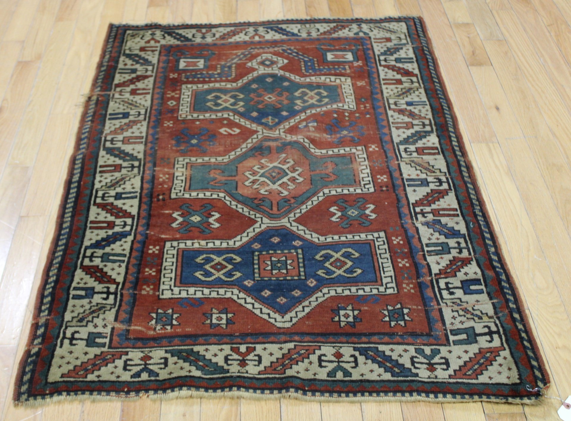 Appraisal: ANTIQUE AND FINELY HAND WOVEN KAZAK STYLE CARPET From a