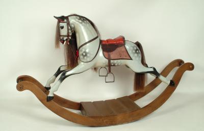 Appraisal: A carved and painted tulip wood rocking horse by Stevenson