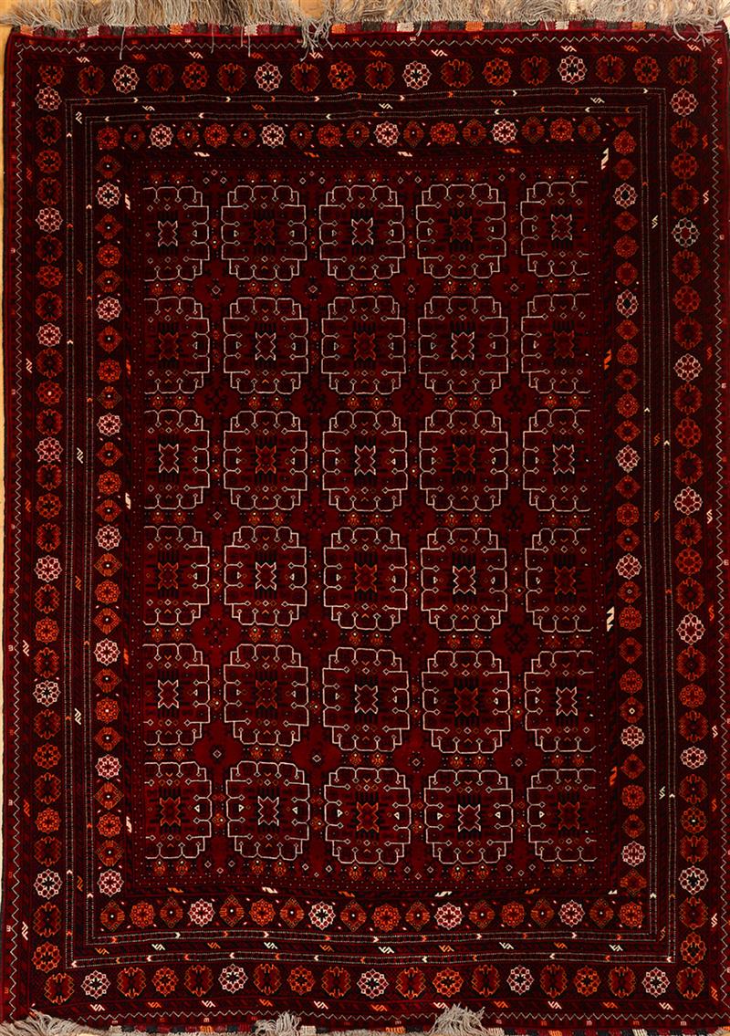 Appraisal: Turcoman Claret-Ground Carpet and a Pakistan Carpet Approx ft in