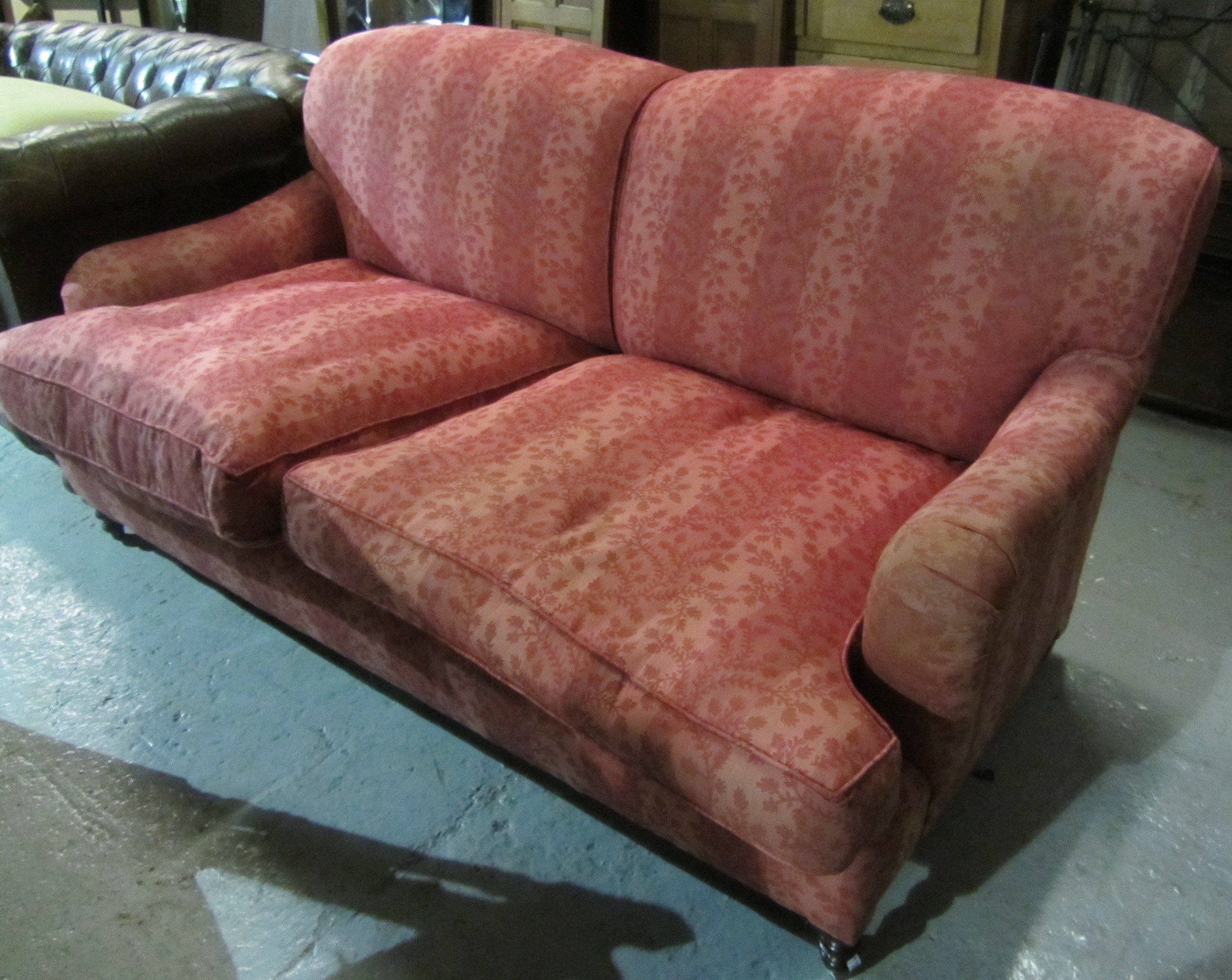 Appraisal: A pair of th century red upholstered sofas