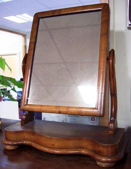 Appraisal: A Victorian toilet mirror the rectangular framed plate on shaped