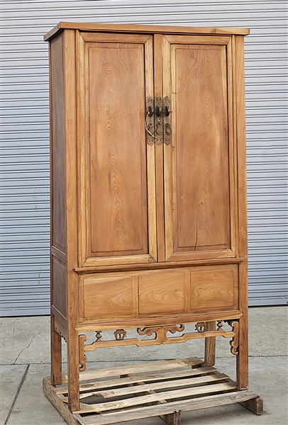 Appraisal: Tall Chinese wood cabinet two doors enclosing two shelves two