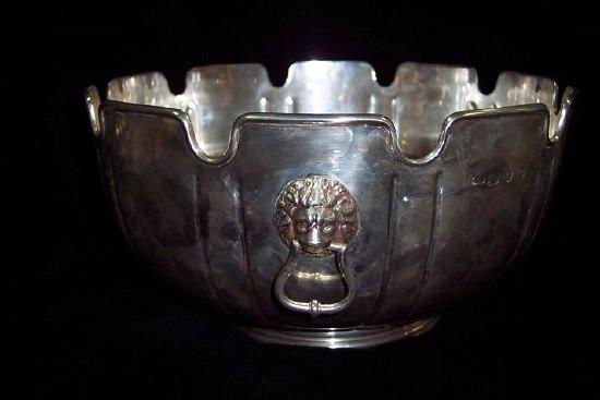 Appraisal: A rosebowl of monteith form with lion mask handles cm