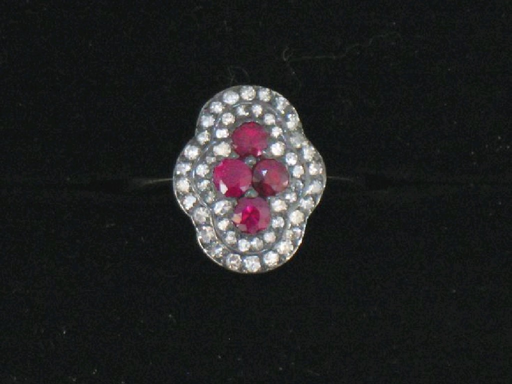 Appraisal: AN EDWARDIAN STYLE RUBY AND DIAMOND DRESS RING the four