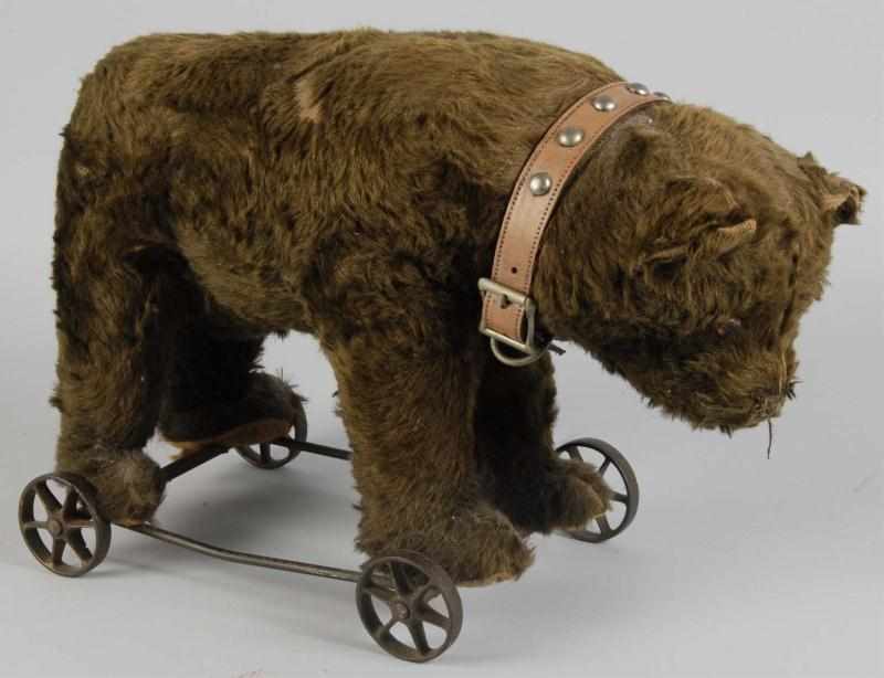 Appraisal: Bear on Wire Platform Toy on Wheels Description German Iron