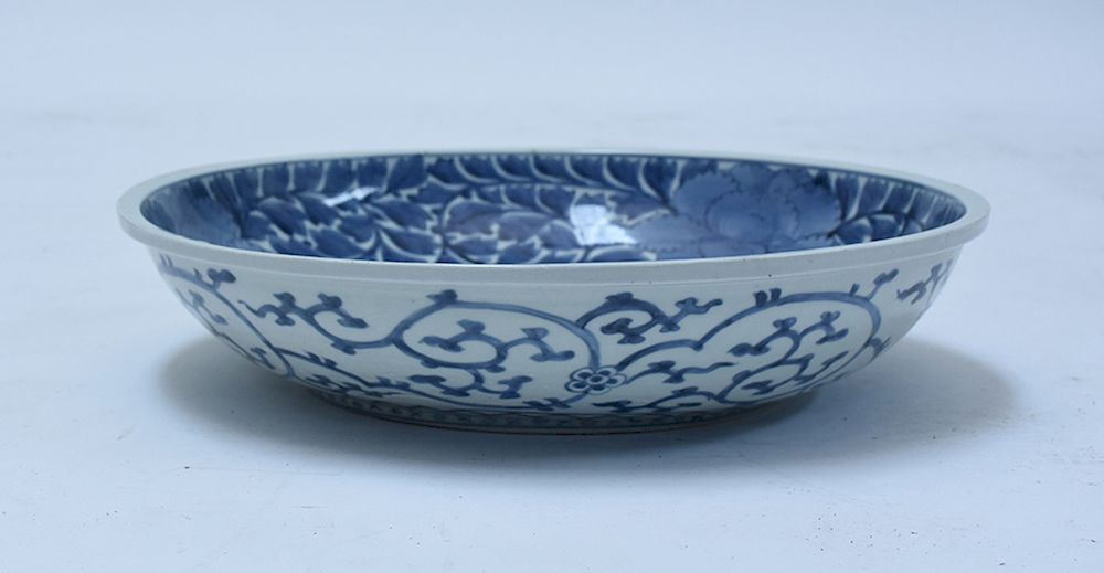 Appraisal: Chinese blue and white low bowl with floral decoration Chinese