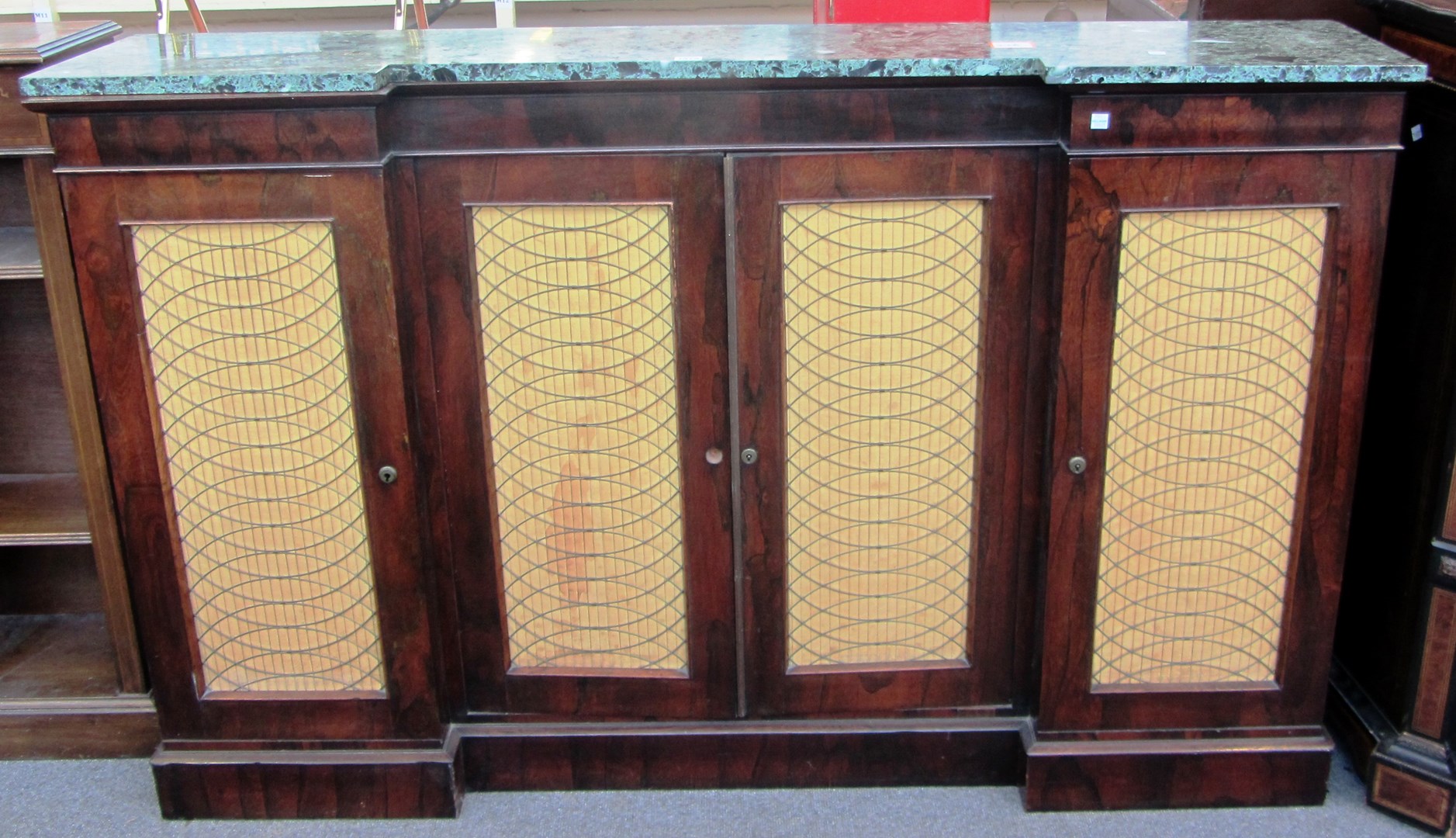 Appraisal: A th century inverted breakfront marble topped rosewood four door